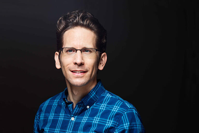Headshot of Wes Holliday against a black background