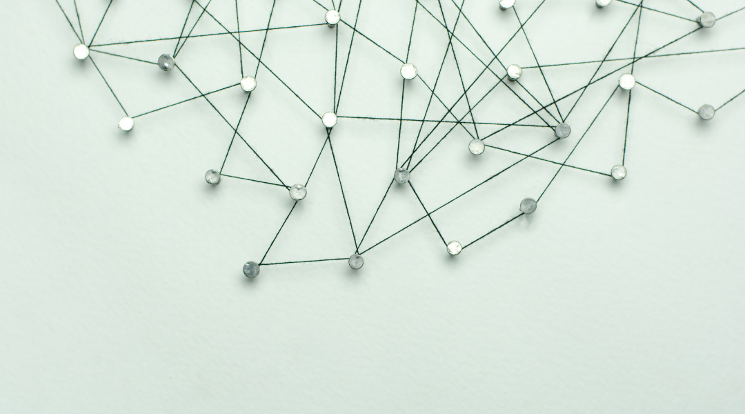 A series of connected pins on a beige board